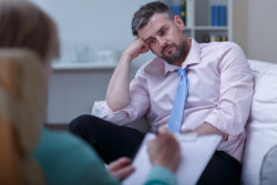 lonely businessman in a psychotherapy session